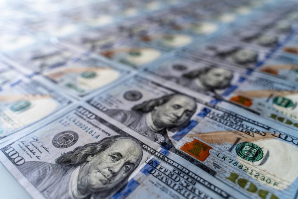 Sheet of 100 dollar bills. 6 figure salary