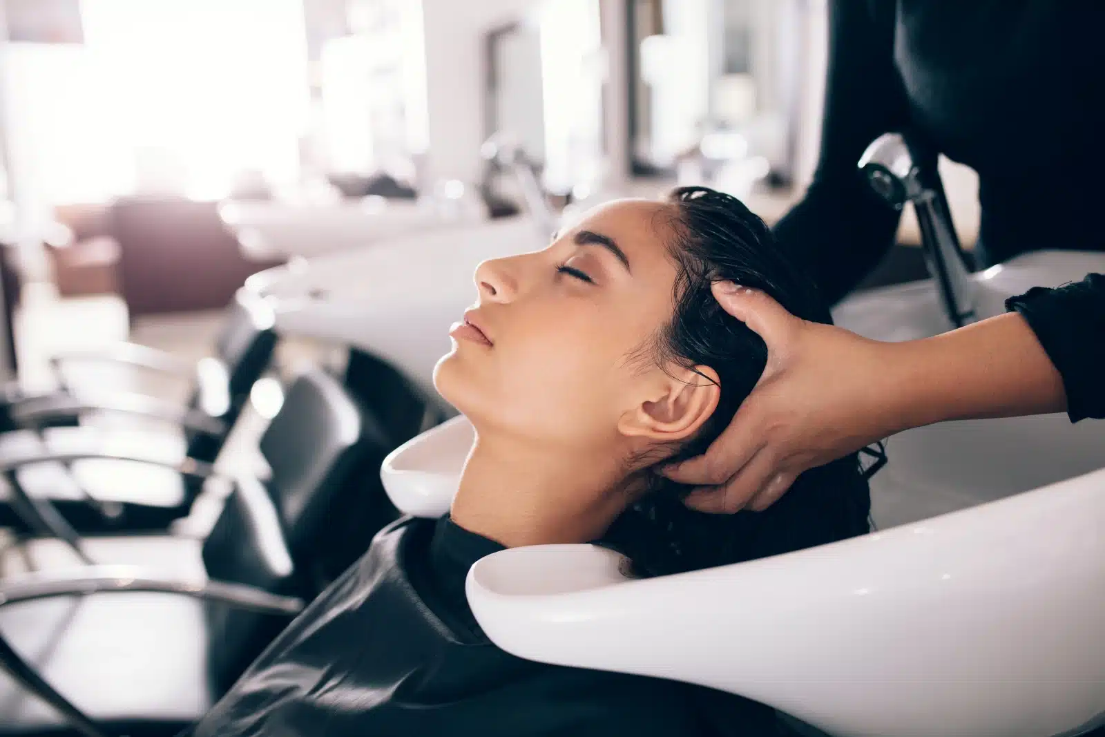 Hair Salon. A woman getting her hair washed at a salon