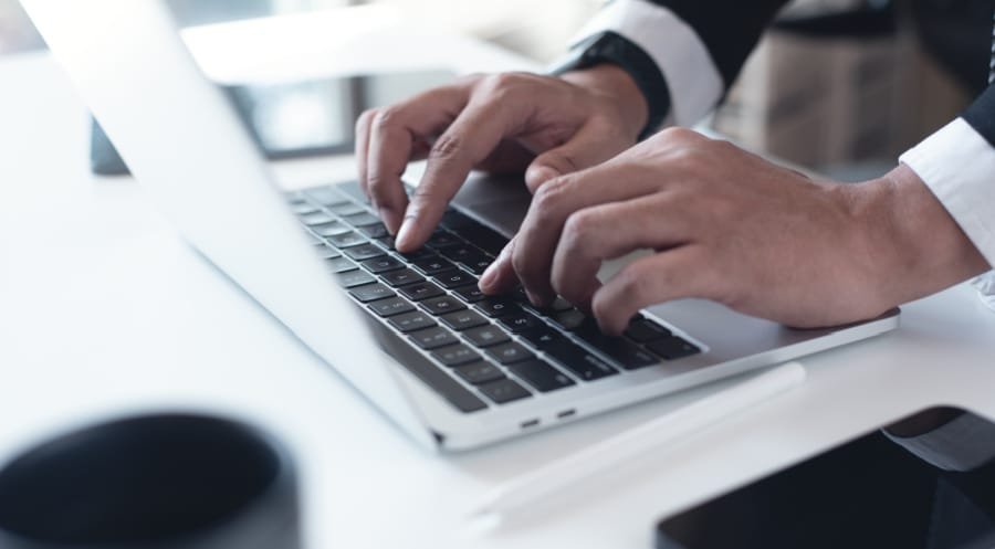 Our Selection Process. Man researching registered agents on a laptop