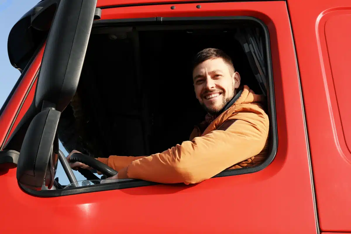 Truck Driver in his truck, smiling