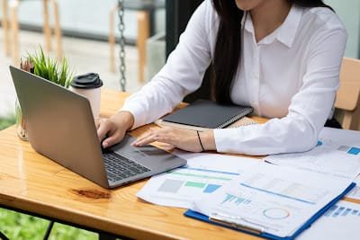 A Louisiana Registered Agent working with a laptop.